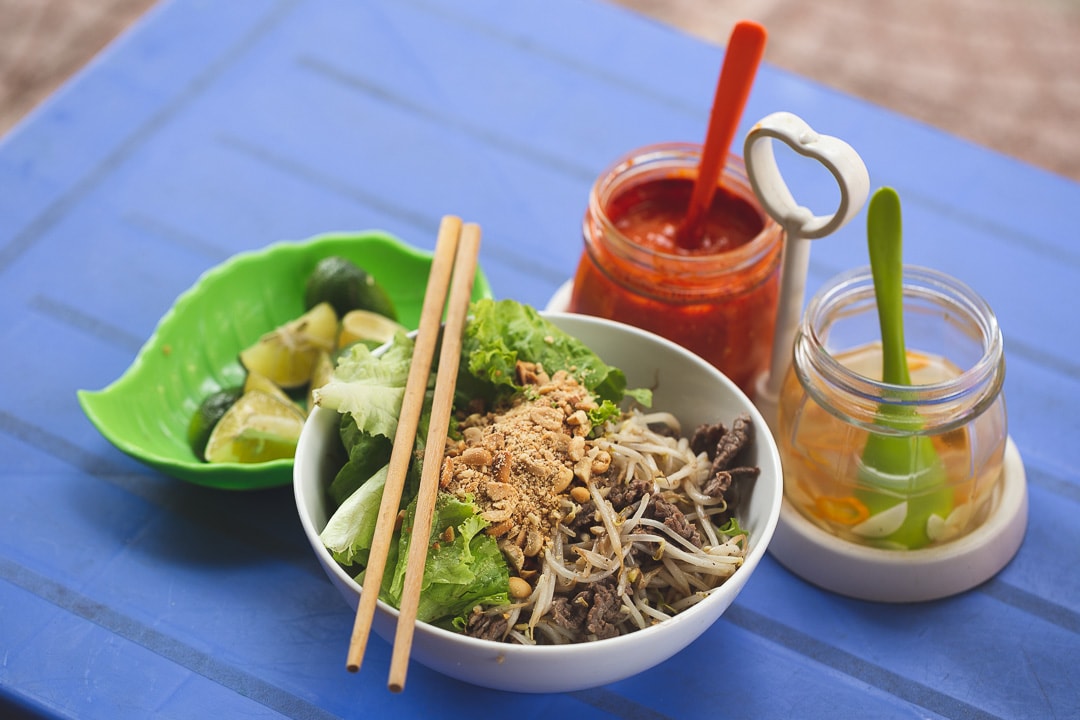 Bun bo nam bo with chili sauce and garlic vinegar. Vietnamese foods you must try in Hanoi.